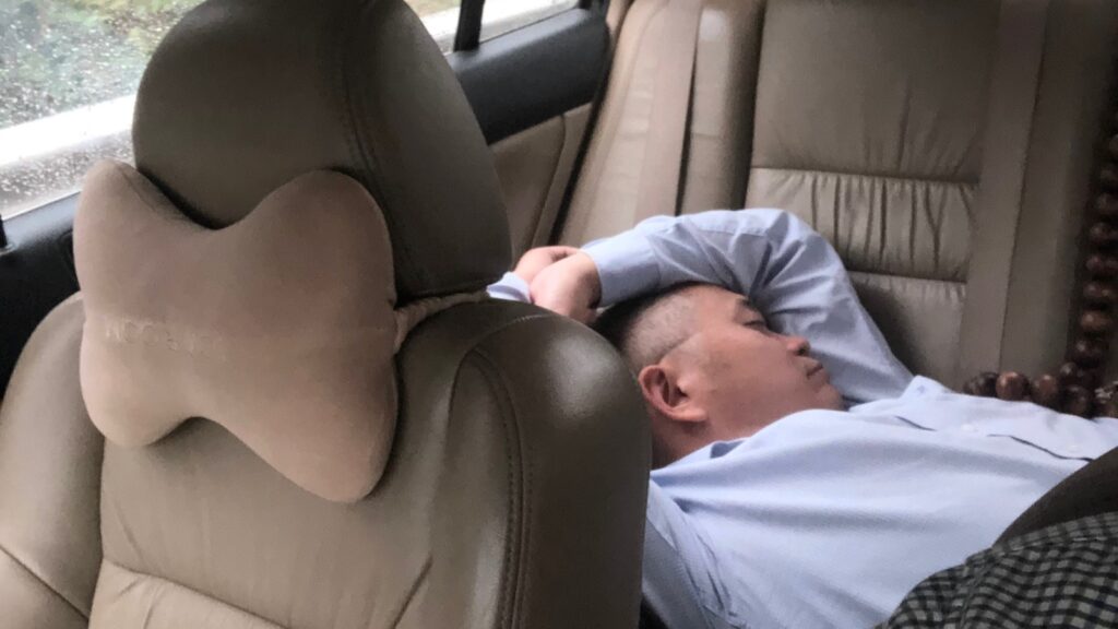 Working with the Mayor - sleeping on the way back from Dongguan.