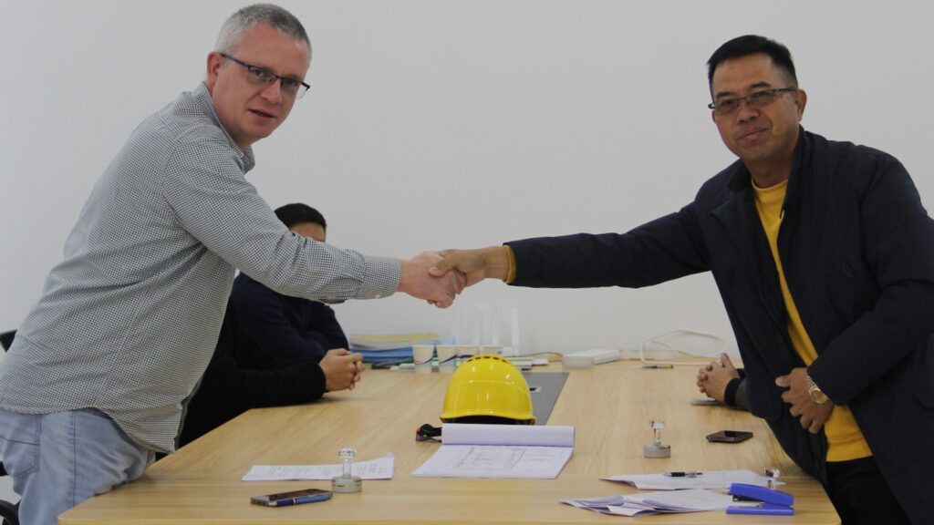 Jay Robertson and Hua Rong Huang sign the agreement to Build Nine Rivers Distillery